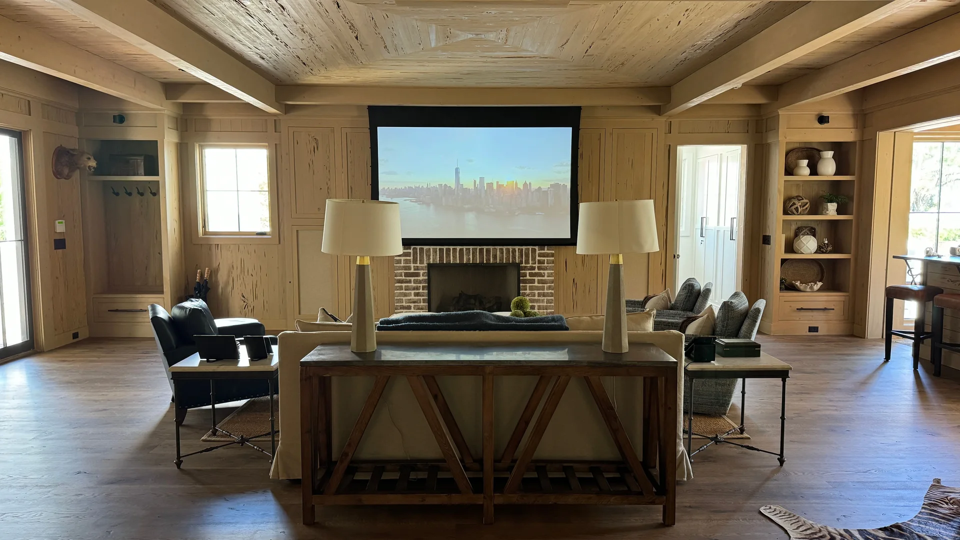 Media room renovation by North South Construction — wood-paneled ceiling, built-ins and brick fireplace
