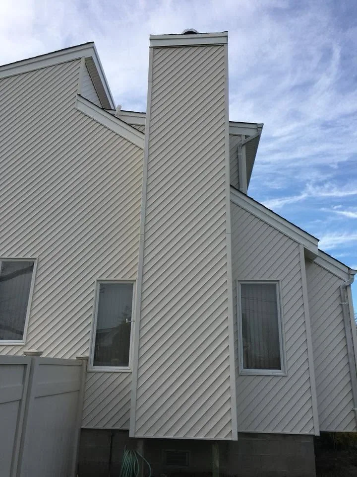 Diagonal siding and chimney exterior by North South Construction
