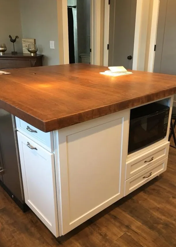 Custom kitchen island with butcher-block top by North South Construction
