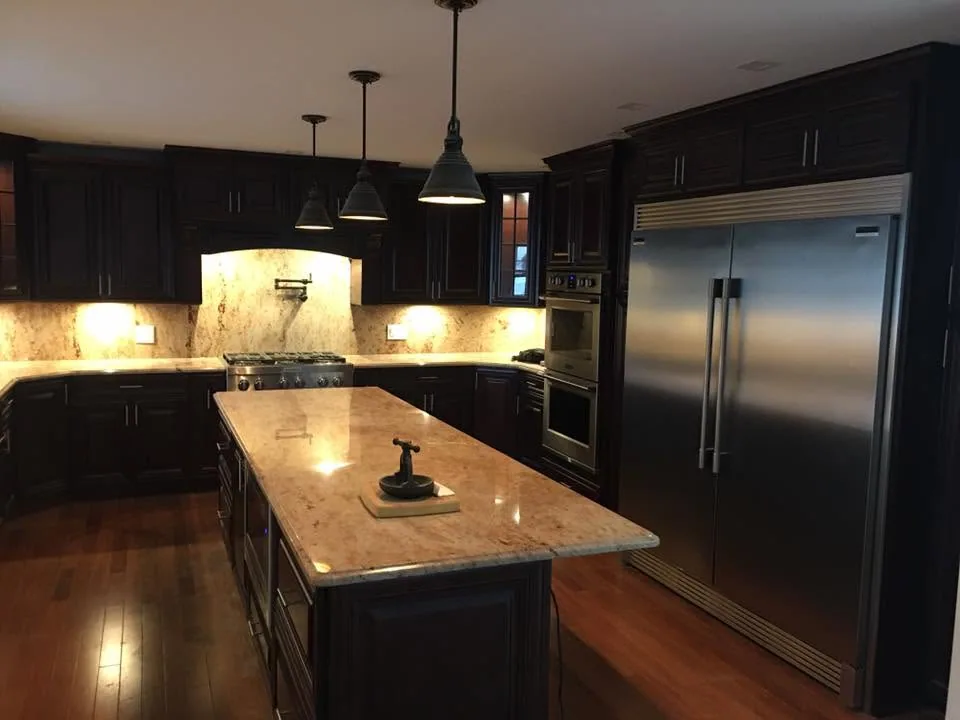 Kitchen remodel with pendant lighting and granite island by North South Construction